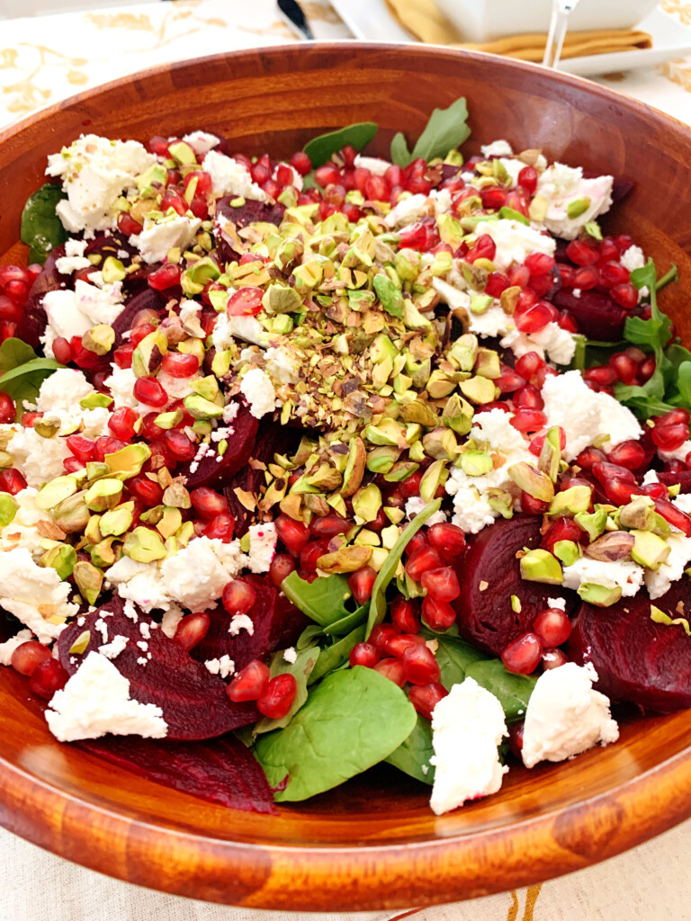 Close up of spinach and beet salad in a wood bowl